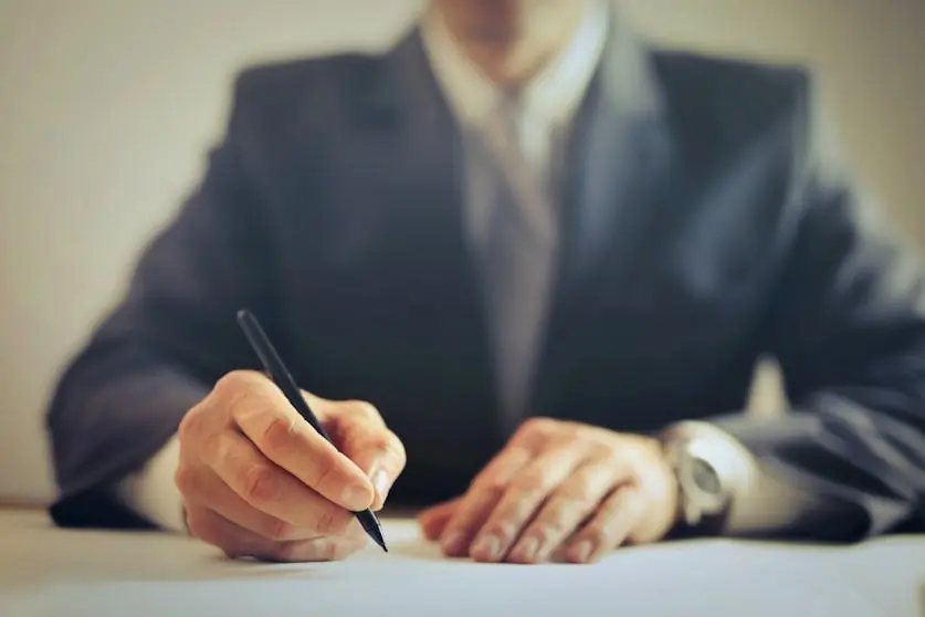 Man writing with a pen.