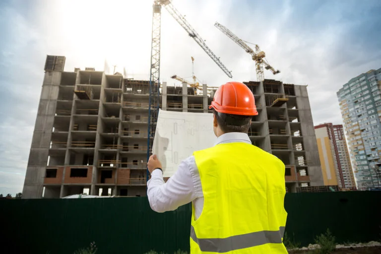An engineer in front of a construction site.