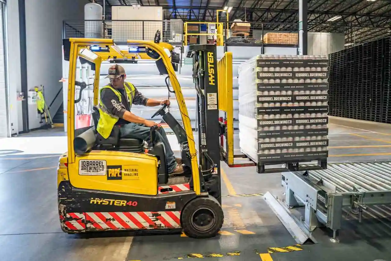 Man driving a yellow forklift.