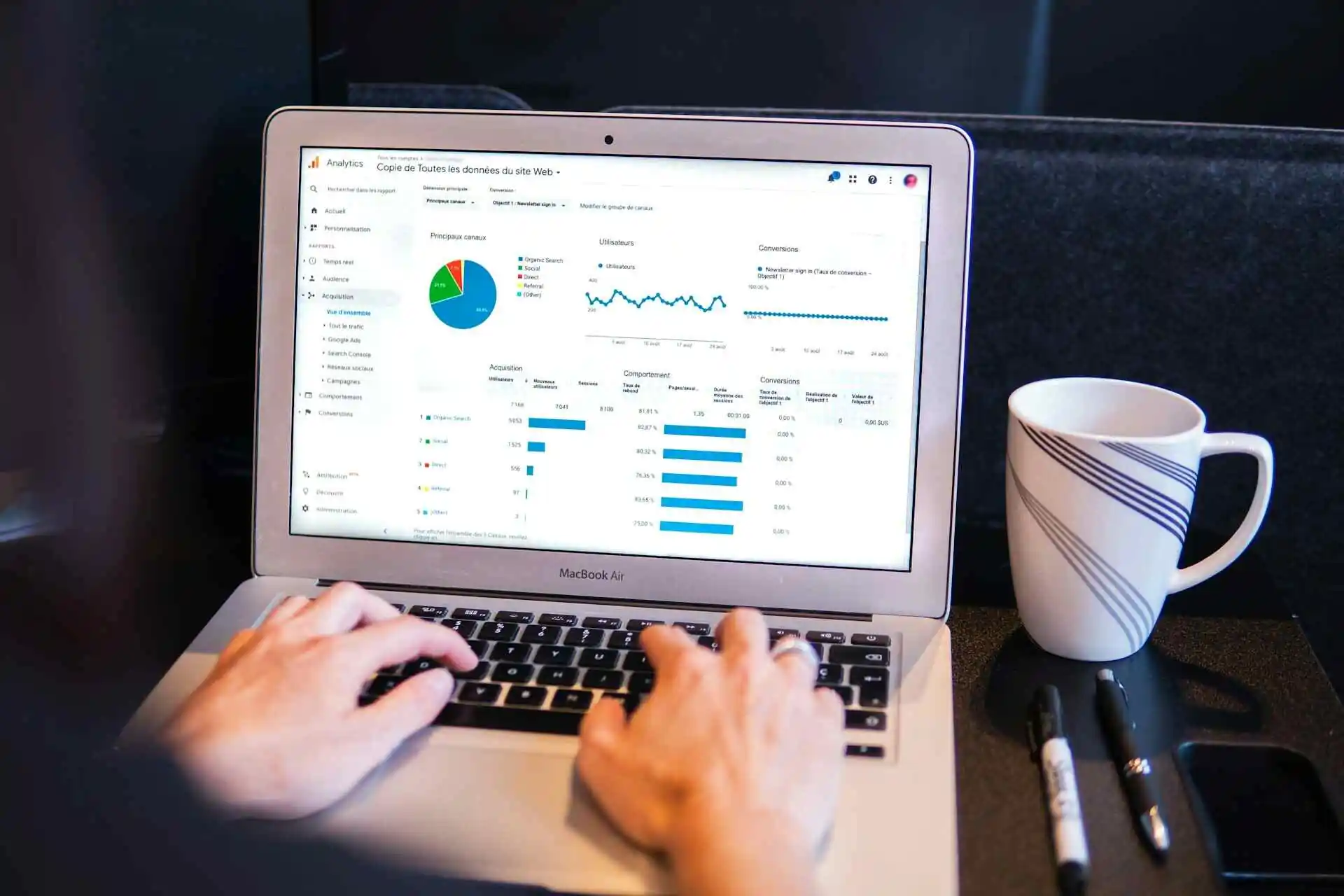 A guy looking at site traffic data on their laptop.