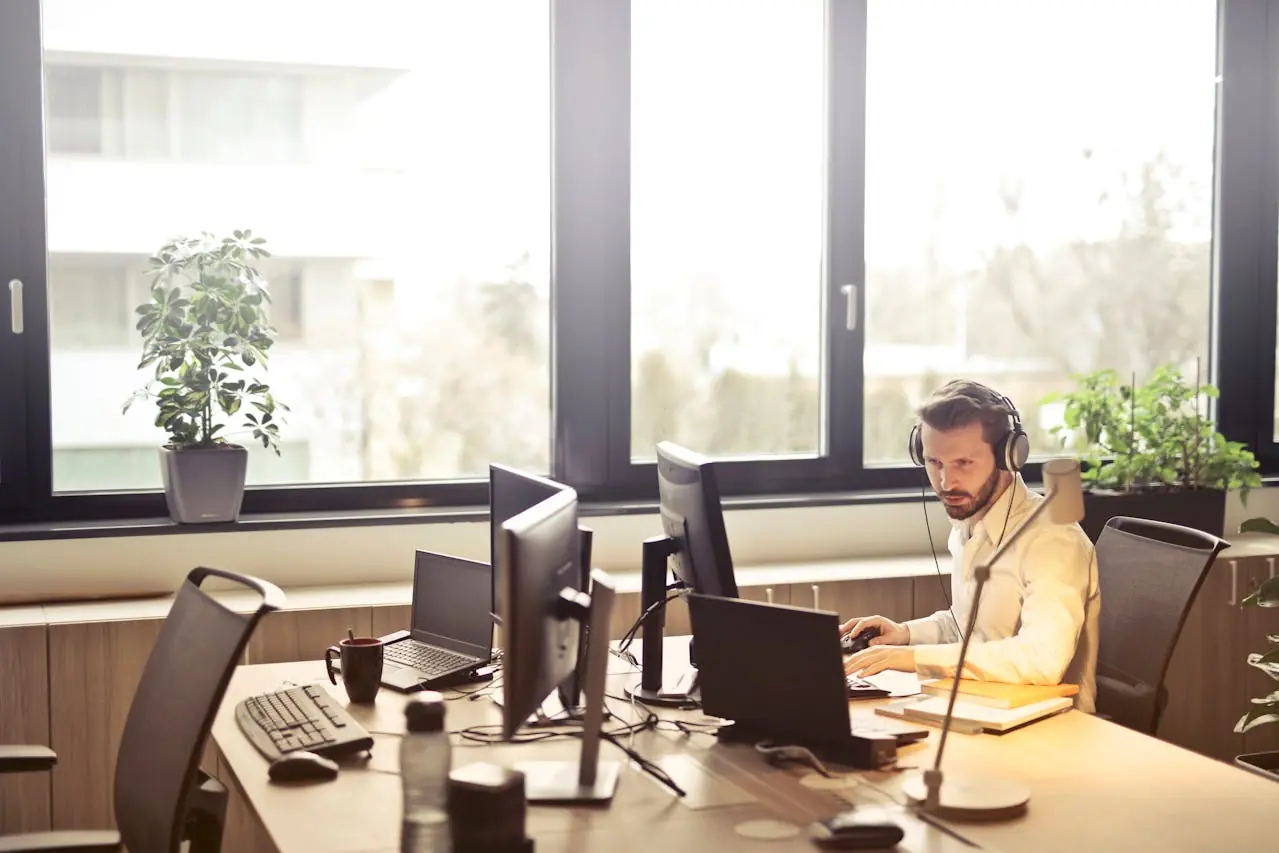 An employee working on their computer in the office. 
